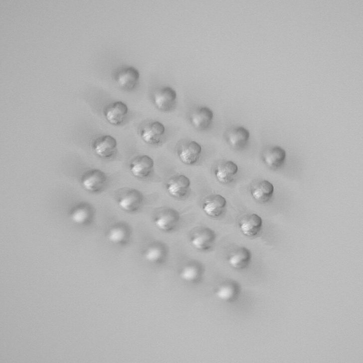 The bottoms of these blind micro-holes have a diameter of 150 μm and are flat to within 5 μm.