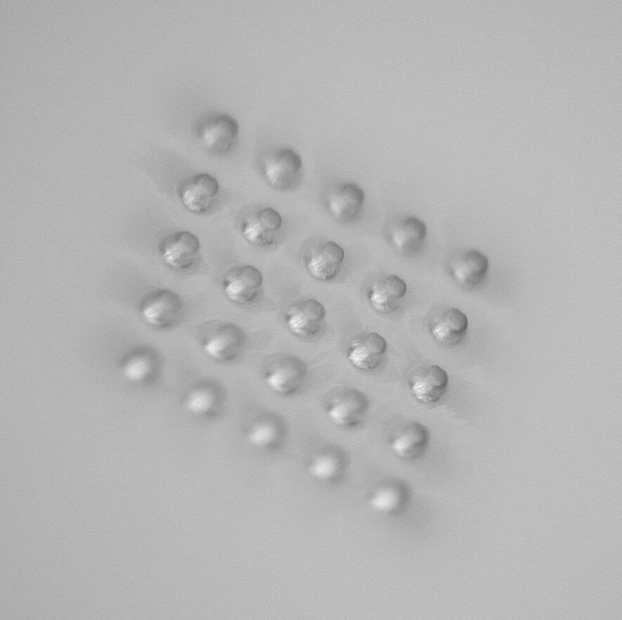 The bottoms of these blind micro-holes have a diameter of 150 μm and are flat to within 5 μm.