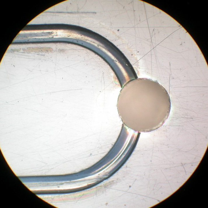 Micro-channels with hemi-spherical bottoms, shown near a via hole.