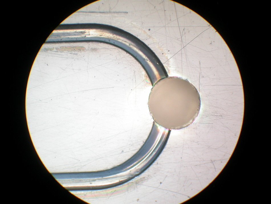 Micro-channels with hemi-spherical bottoms, shown near a via hole.