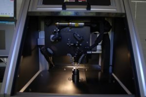 The beam delivery is integrated with a video microscope and optics mounted on stages. The optics and beam delivery module retracts for safe and easy part loading and unloading.